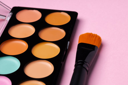 Make up palette with brush on pink backgroundの写真素材