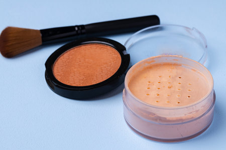 Decorative cosmetics face powder and brush close up