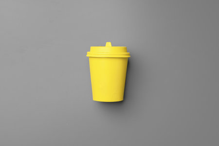 Disposable coffee cup in yellow gray colorsの写真素材