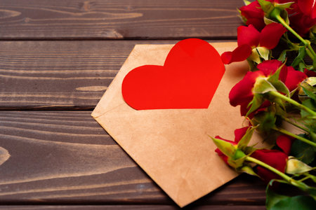 Bouquet of roses and envelope top view