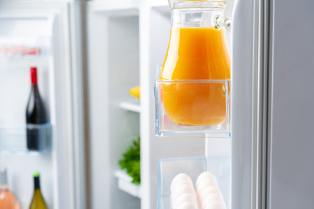 Open fridge full of fresh food and drinksの写真素材