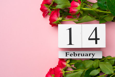 Wooden calendar 14th February and roses on pink backgroundの写真素材