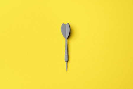 Gray dart arrow on yellow background flat layの写真素材