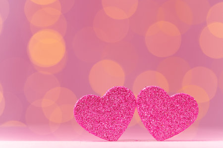 Pink glitter heart decoration on pink backgroundの写真素材