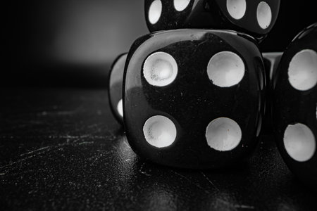 Group of playing dice cubes on black surface, macroの写真素材