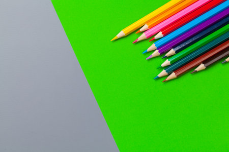 Colored pencils on bright color paper backgroundの写真素材