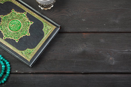 Three months. Islamic Holy Book Quran with rosary beads. Ramadan concept