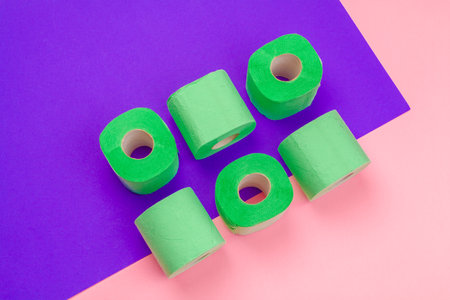 Green toilet paper roll on bright color block background top viewの写真素材
