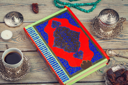 Colorful Koran with rosary on the wooden background. Holy book for Muslims for Ramadan concept
