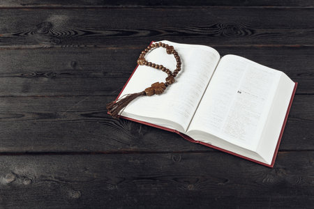 Bible and a crucifix on an old wooden table. Religion concept.の写真素材
