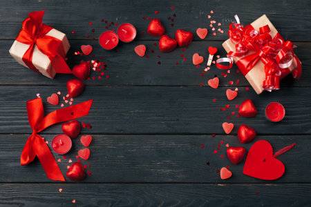 Gift box with red hearts on wooden tableの写真素材