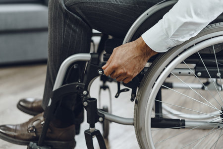 Unrecognizable man sitting in wheelchair close up