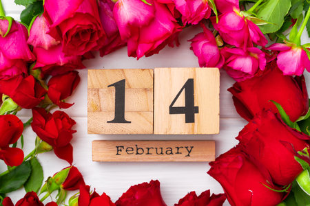 Wooden calendar 14th February and roses on white backgroundの写真素材