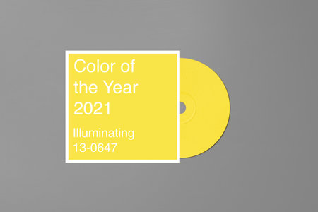 Yellow CD disc on gray background top viewの写真素材