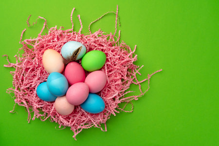 Easter eggs in a nest on green background