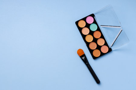 Complexion make up products and brush on blue backgroundの写真素材