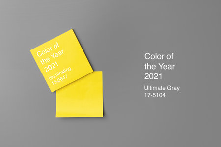 Yellow adhesive notes on gray background close up