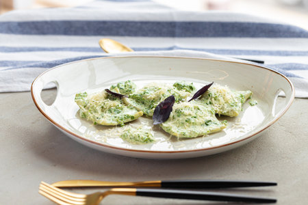 Russian dumpling served with parsley and cheese on plateの写真素材