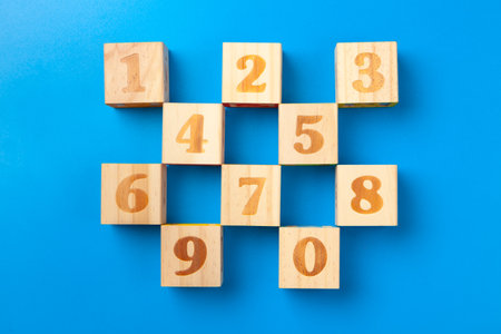 Numbers. Wooden colorful alphabet blocks on blue background, flat lay, top view.の写真素材