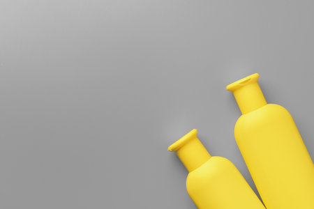 Yellow cosmetic container on gray background top viewの写真素材