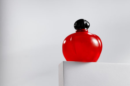 Fragrance bottle on gray block against gray backgroundの写真素材
