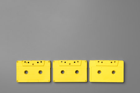 Yellow audio cassettes on gray background top viewの写真素材