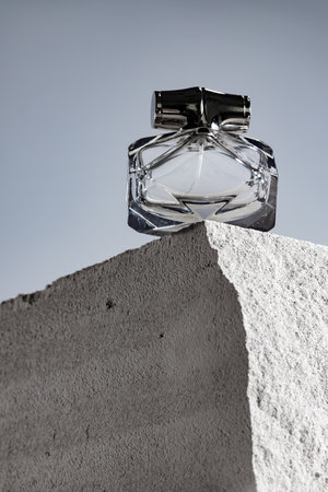 Transparent fragrance bottle on gray .cinder blockの写真素材