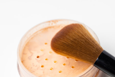 Decorative cosmetics face powder and brush close up