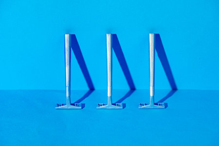 Disposable razors on blue background, studio shotの写真素材