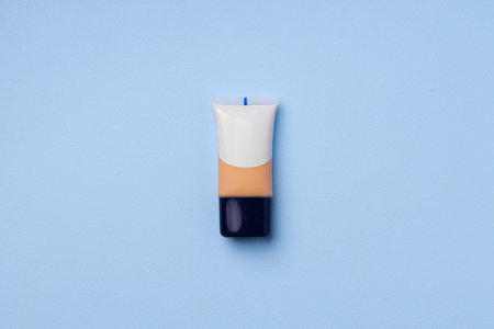 Liquid foundation tube on blue background close upの写真素材