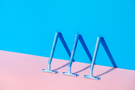Disposable razor on blue and pink backgroundの写真素材