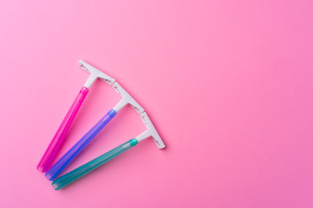 Female disposable razors on pink background top viewの写真素材