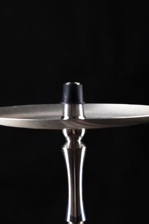 Ceramic tobacco bowl of hookah on black background
