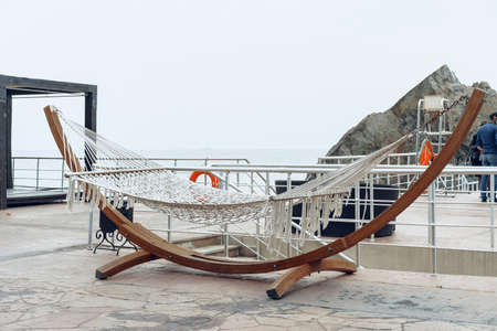 Woven swing on luxury hotel terrace near seaの写真素材