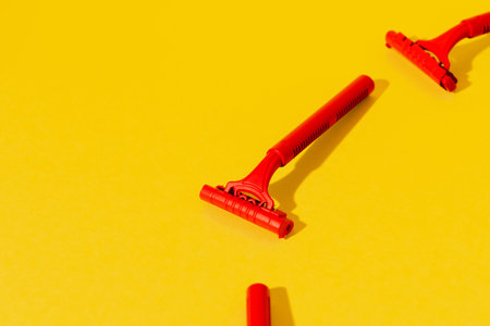 Disposable razors on yellow background, studio shotの写真素材