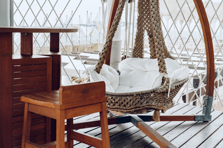 Woven swing on luxury hotel terrace near seaの写真素材