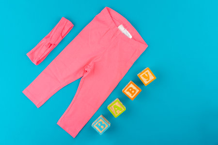 baby clothes on blue background top viewの写真素材