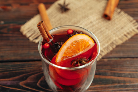 Close up of mulled wine cup with spices and berries on grey tableの写真素材