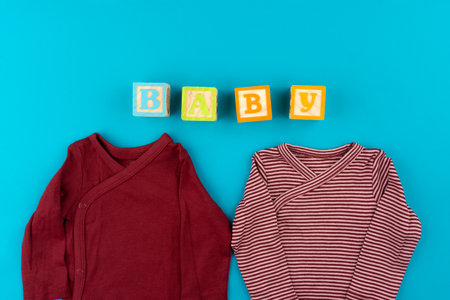 baby clothes on blue background top viewの写真素材