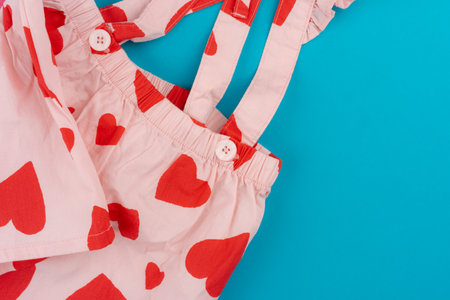 Top view of baby clothes on blue background