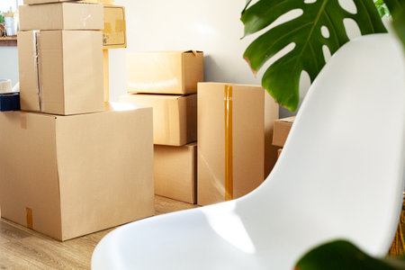 House moving concept with stacked cardboard boxes in a roomの写真素材