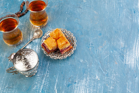 Top view of big metal tray with turkish baklava on planked wooden tableの写真素材