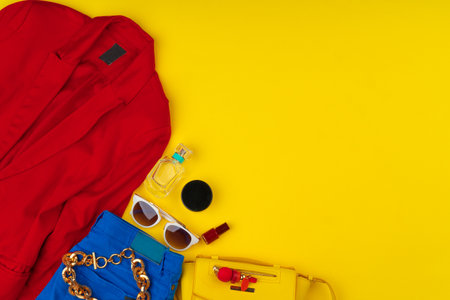 Trendy woman outfit with accessories on bright yellow backgroundの写真素材
