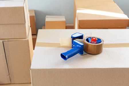 House moving concept with stacked cardboard boxes in a room