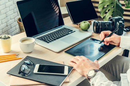 Close up of a working table of a businessman with laptopの写真素材