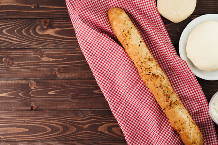 Baguette bread on brown wooden board close upの写真素材