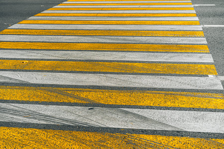 Crosswalk on the asphalt road in a city streetの写真素材