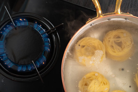 Cooking pasta at home in a pot close upの写真素材