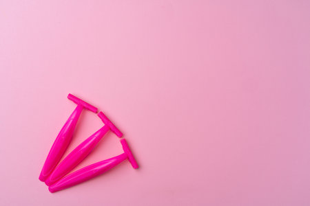 Female disposable razors on pink background top viewの写真素材