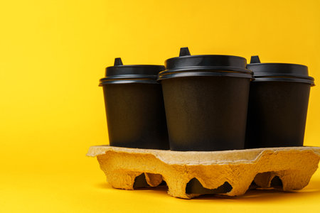 Black take away coffee cups in holderの写真素材